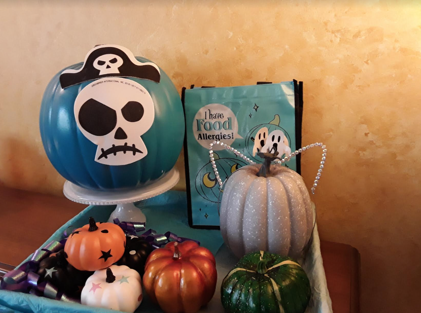 Blue tray with several small decorative pumpkins